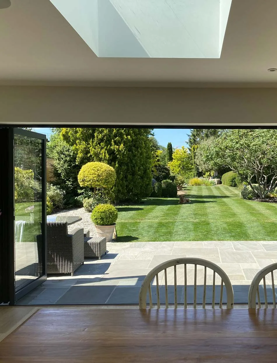 Aluminium bi-fold doors open to a garden