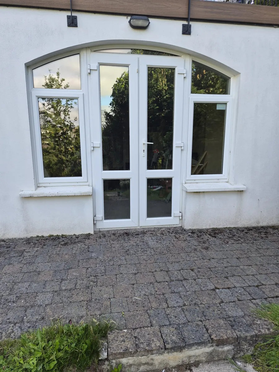 Arched uPVC door replacement in Co. Wicklow — old double doors before